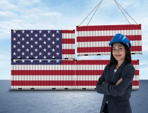 Female U.S. importer in front of cargo containers painted with the American flag