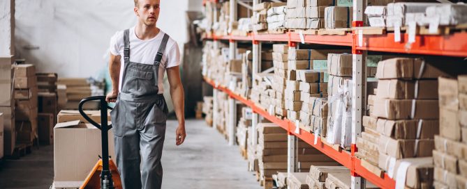 Warehouse worker pulling a pallet jack